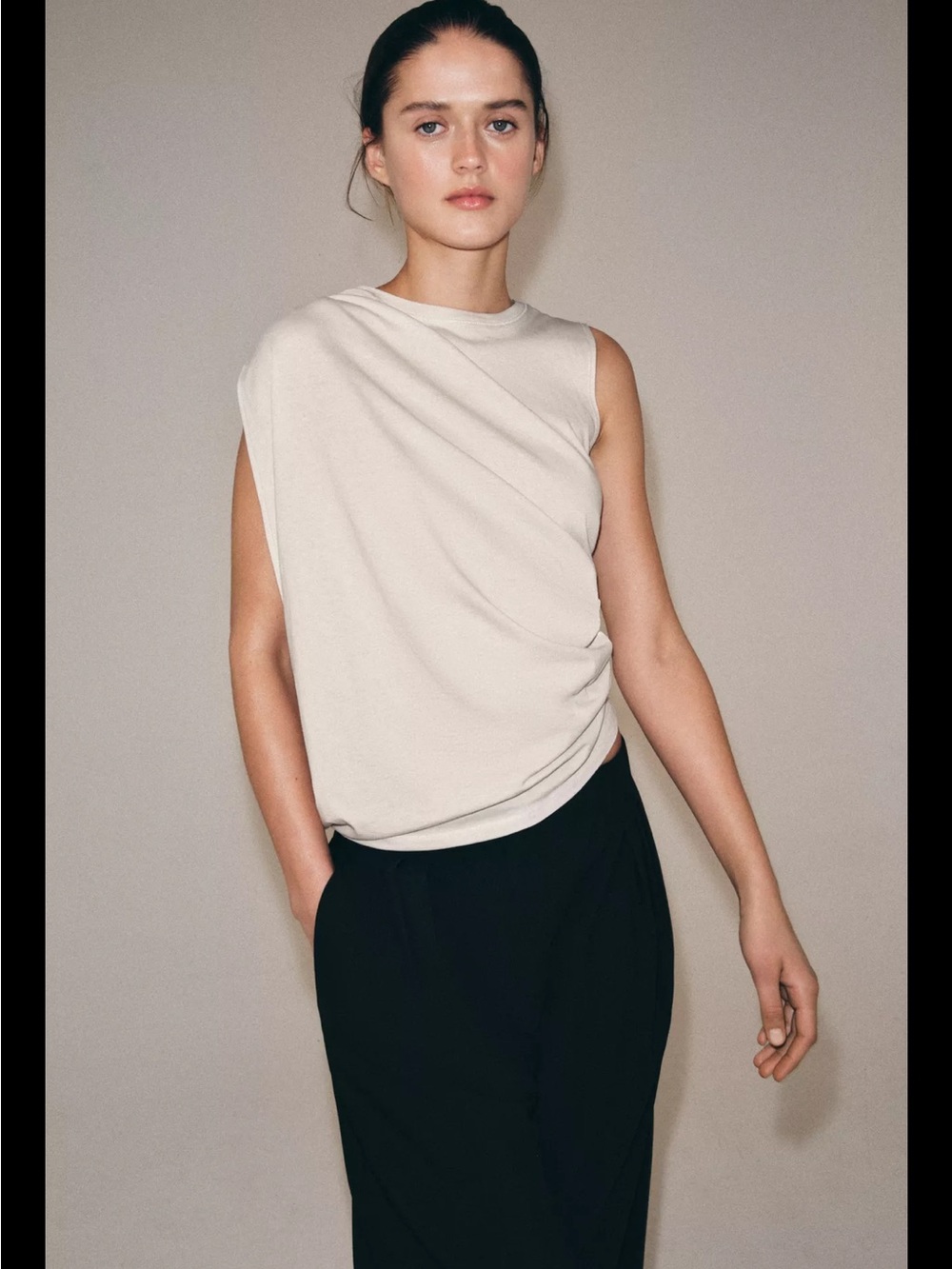 Draped asymmetric top in stone